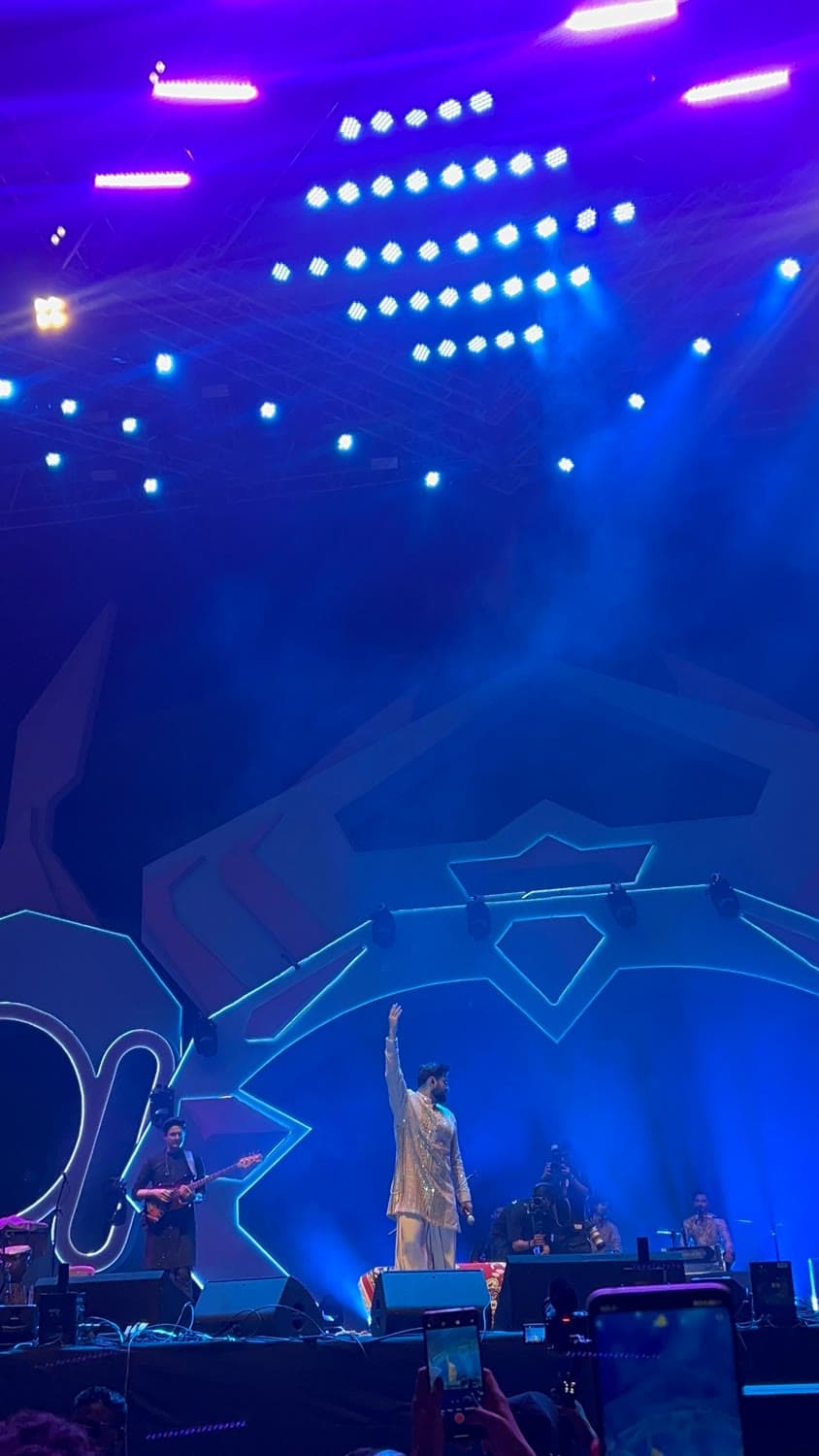 A singer on the pronite stage under blue light