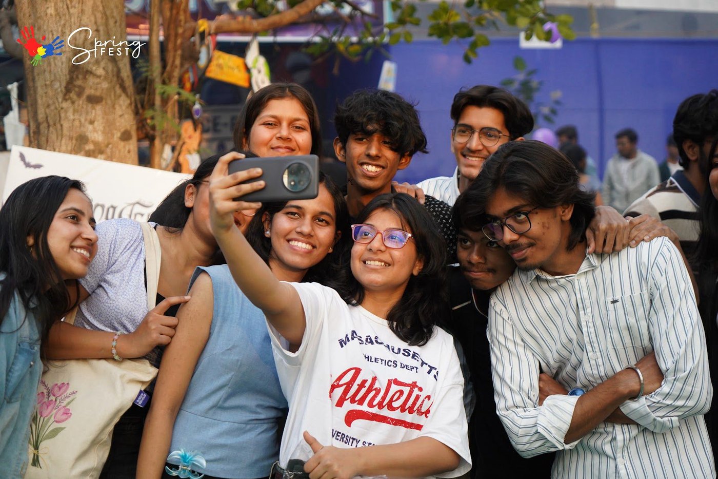 Students crowding into one selfie on campus at Spring Fest
