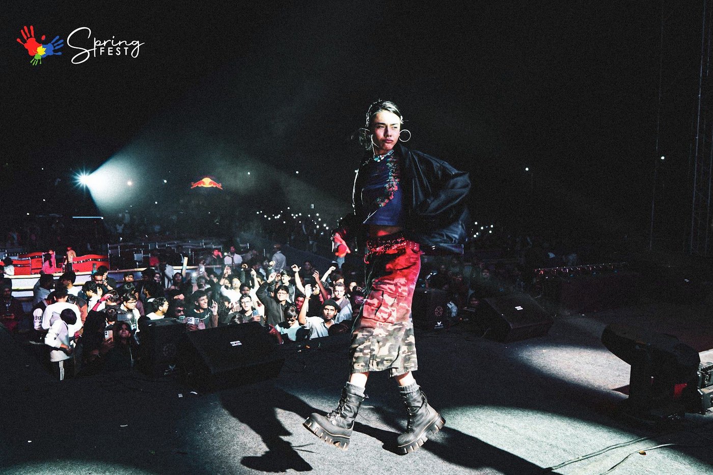 A model walking the ramp at night with the crowd behind