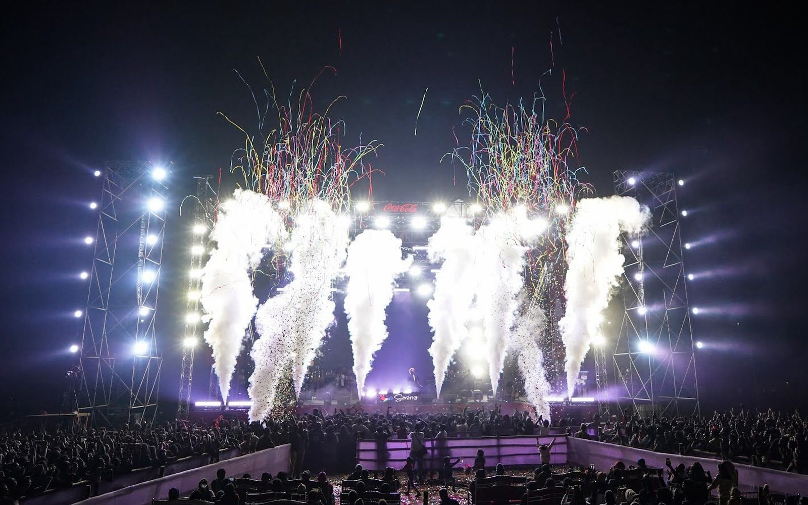 Jets of smoke and confetti over the main stage, the crowd in front of it